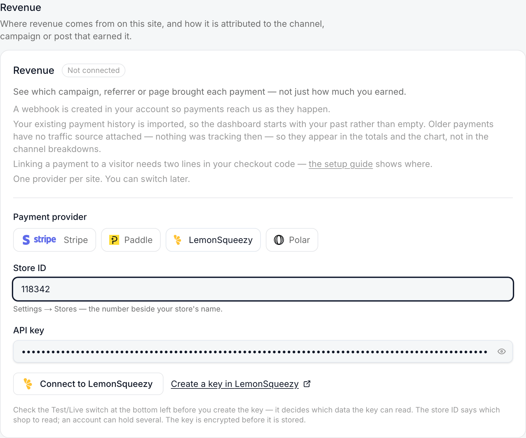 The Revenue card with LemonSqueezy chosen: the Store ID field filled, the API key field filled, and the note about the Test/Live switch